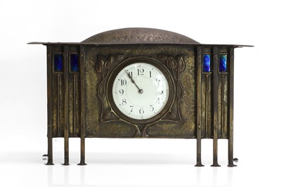Lot 167 - A Glasgow School planished brass mantel clock
