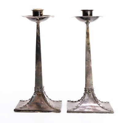 Lot 165 - A pair of Arts and Crafts silver candlesticks