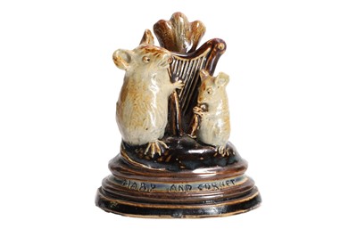 Lot 171 - A Doulton Lambeth 'Mouse Musician' stoneware menu holder