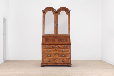 Lot 373 - A Queen Anne walnut and feather-banded bureau bookcase