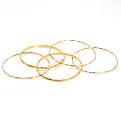 Lot 329 - A group of five gold bangles