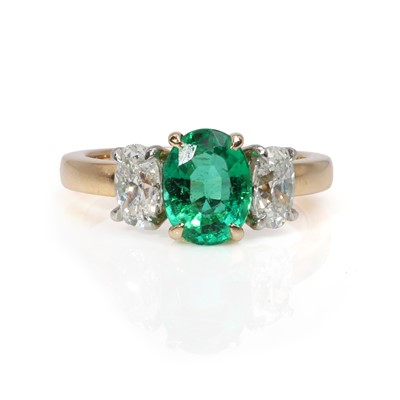 Lot 152 - An 18ct gold emerald and diamond three stone ring