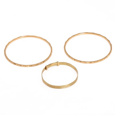 Lot 330 - A group of three gold bangles