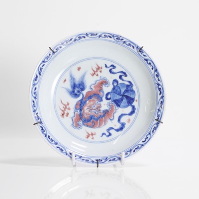 Lot 83 - A Chinese copper-red and underglaze blue saucer