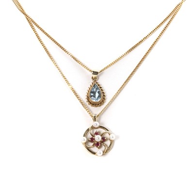 Lot 274 - A 9ct gold aquamarine pendant and a 9ct gold ruby and seed pearl pendant