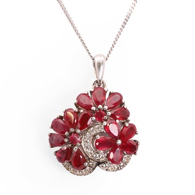 Lot 100 - A ruby and white sapphire floral pendant