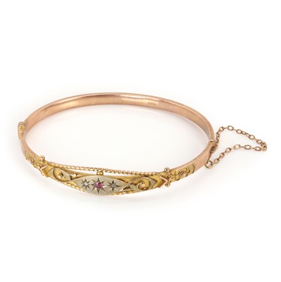 Lot 32 - An Edwardian 9ct gold ruby and rose cut diamond bangle