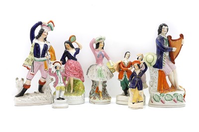 Lot 80 - A collection of seven Staffordshire pottery figures