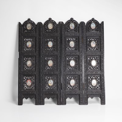 Lot 147 - An Anglo-Indian carved hardwood table screen