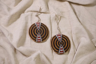 Lot 371 - A pair of beaded hide tipi ornaments