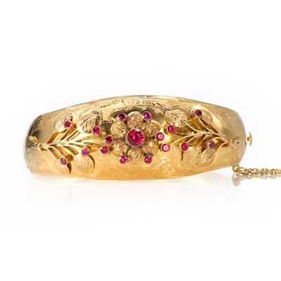 Lot 106 - A gold and synthetic ruby floral bangle