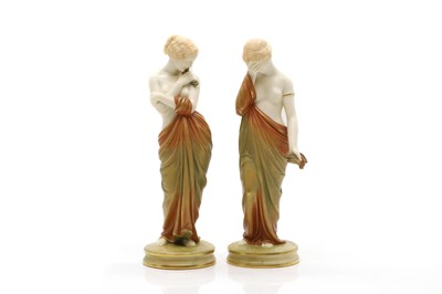 Lot 106 - A pair of Royal Worcester biscuit glazed figures