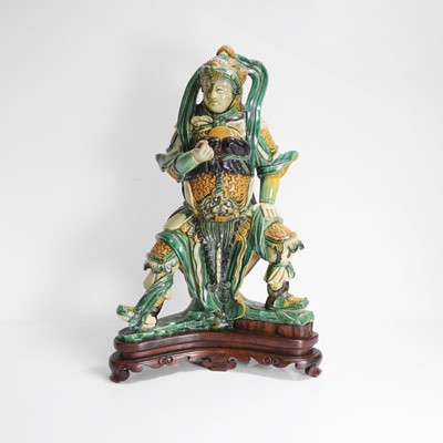Lot 28 - A Chinese sancai-glazed guardian