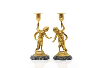 Lot 490 - A pair of gilt metal candlesticks