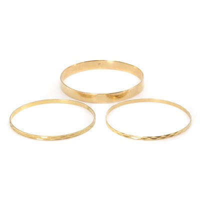 Lot 326 - A group of three gold bangles