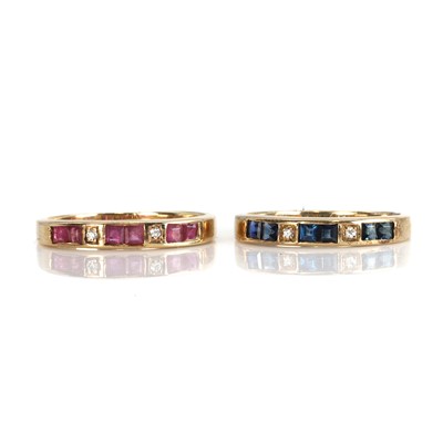 Lot 257 - A set of two 9ct gold ruby, sapphire and diamond half eternity rings