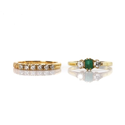 Lot 256 - An emerald and diamond ring and a diamond half eternity ring