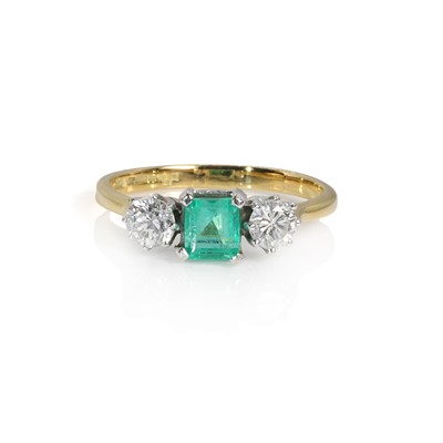 Lot 155 - An 18ct gold emerald and diamond three stone ring