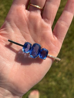 Lot 104 - A sapphire three stone bar brooch