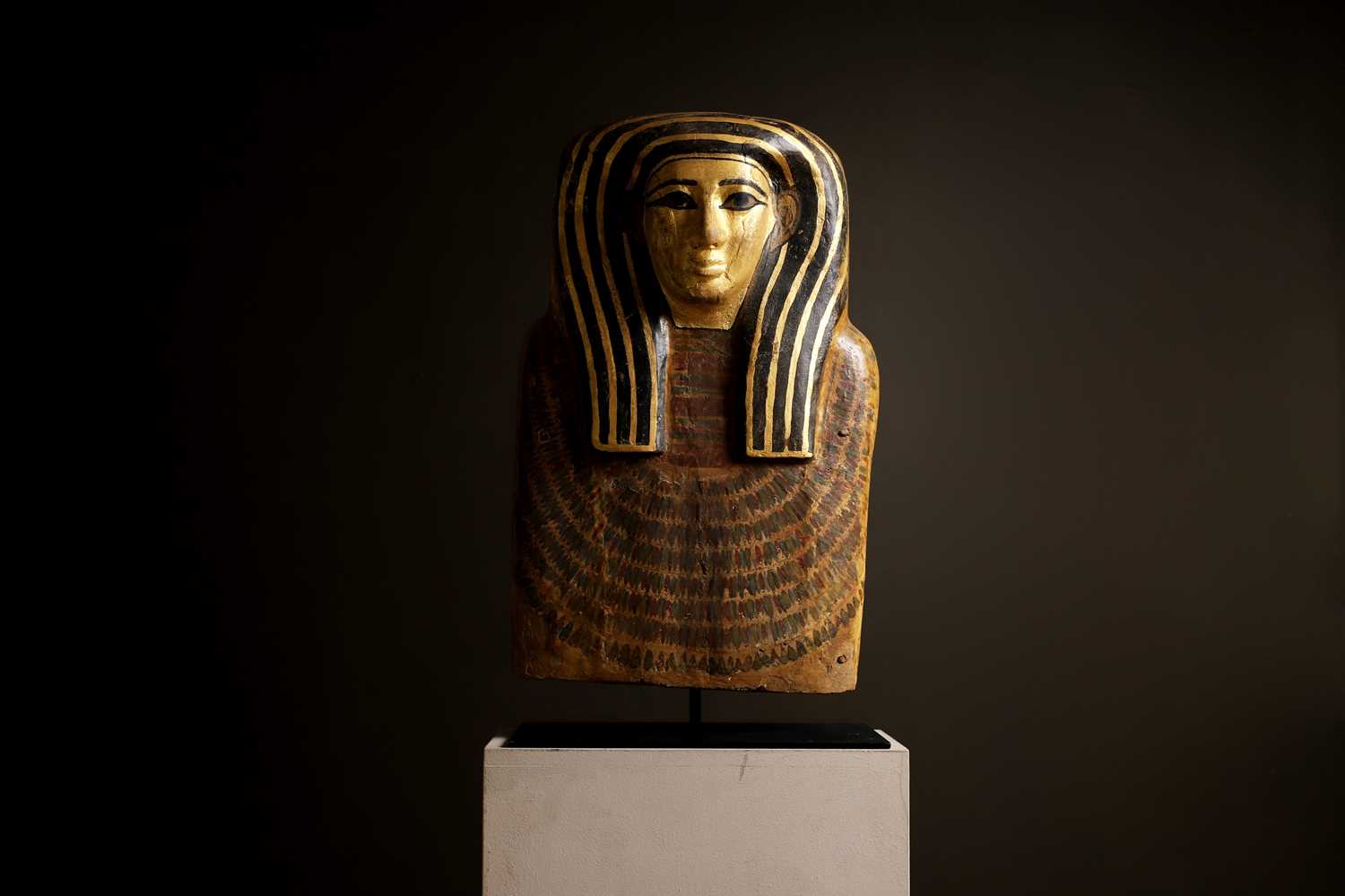 Lot 279 - An Egyptian painted wood sarcophagus or coffin lid
