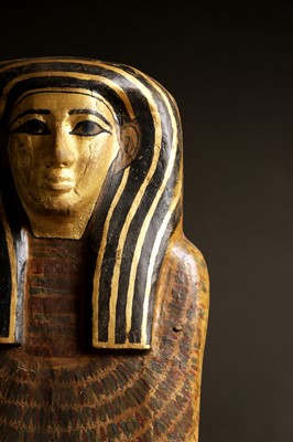 Lot 279 - An Egyptian painted wood sarcophagus or coffin lid
