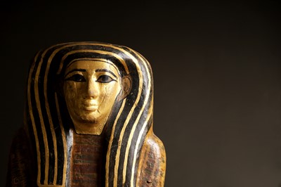 Lot 279 - An Egyptian painted wood sarcophagus or coffin lid