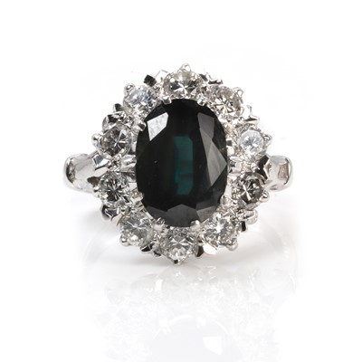 Lot 235 - A white gold sapphire and diamond cluster ring