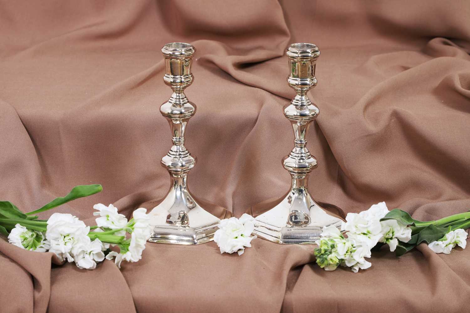 Lot 630 - A pair of Queen Anne silver candlesticks