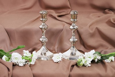 Lot 630 - A pair of Queen Anne silver candlesticks