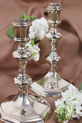 Lot 630 - A pair of Queen Anne silver candlesticks