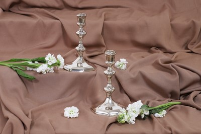 Lot 630 - A pair of Queen Anne silver candlesticks