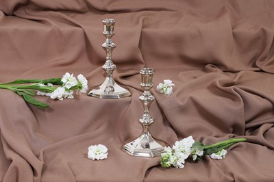 Lot 630 - A pair of Queen Anne silver candlesticks