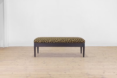 Lot 633 - An imitation leopard-skin and ebonised wooden ottoman