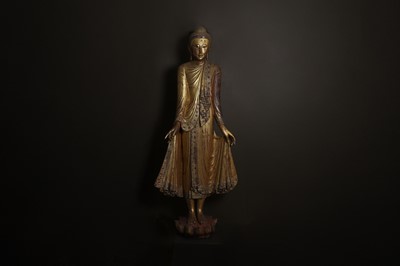 Lot 637 - A very large lacquered and giltwood figure of the standing Buddha