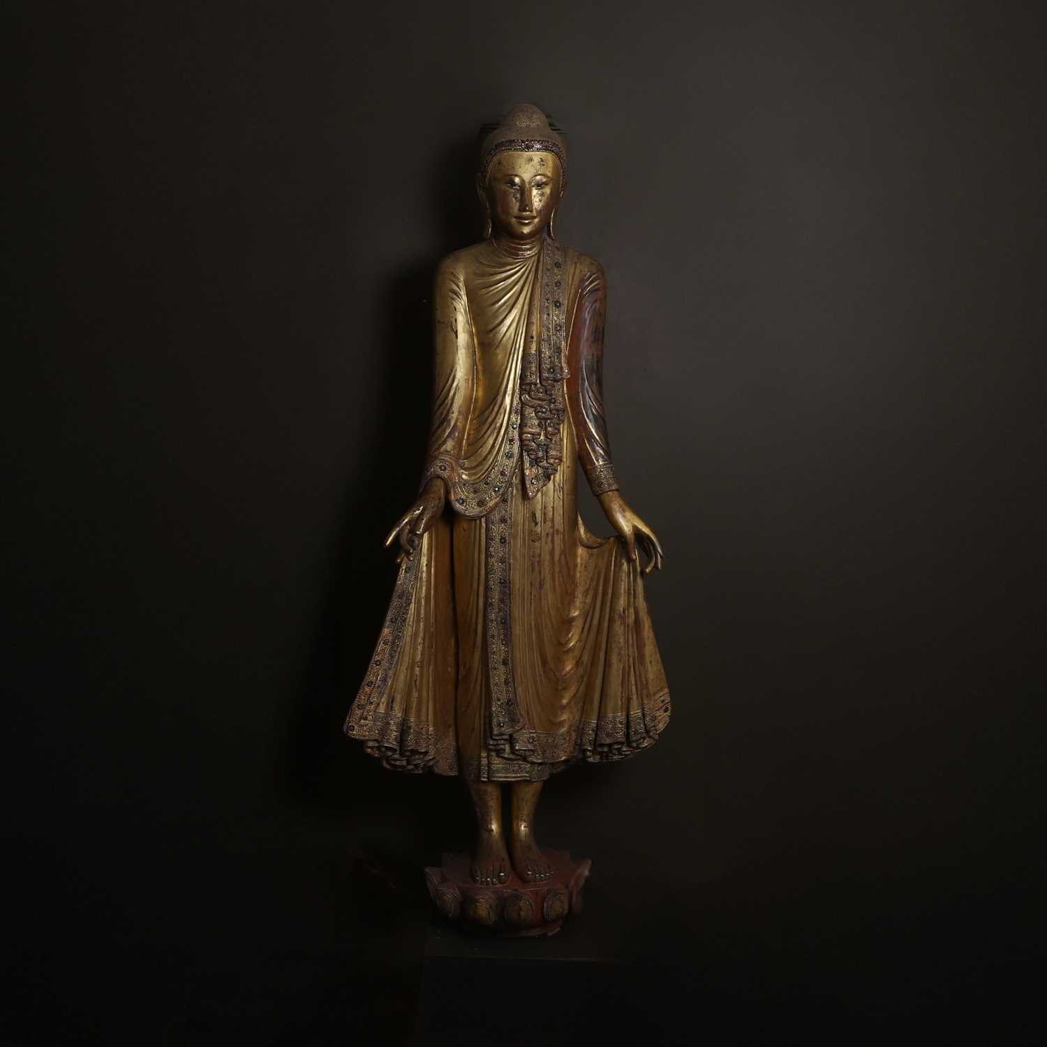 Lot 637 - A very large lacquered and giltwood figure of the standing Buddha