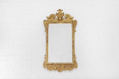 Lot 555 - A George I-style carved giltwood and gesso mirror