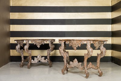 Lot 363 - A pair of rococo silvered console tables