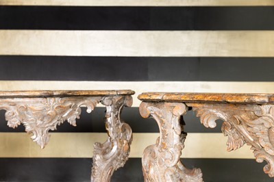 Lot 363 - A pair of rococo silvered console tables