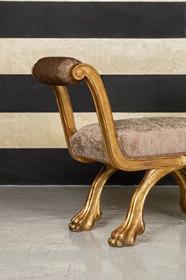 Lot 340 - A giltwood curule window seat