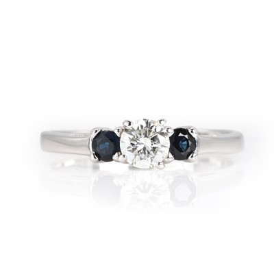 Lot 288 - A 14ct white gold diamond and sapphire three stone ring