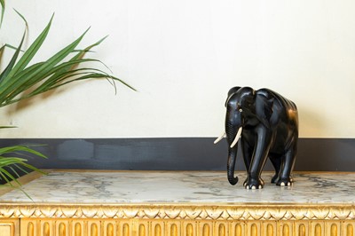 Lot 30 - An ebonised carved wood elephant