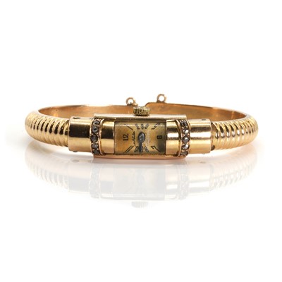 Lot 418 - A ladies' gold diamond mechanical bracelet watch