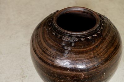 Lot 22 - A black-glazed terracotta water jar