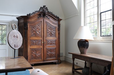 Lot 586 - ​​A carved carruba wood armoire
