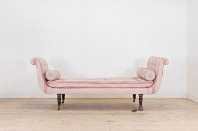 Lot 576 - A Regency-style ebonised and parcel-gilt chaise longue