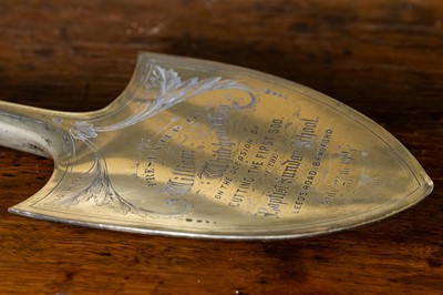 Lot 264 - An ebonised wooden and silver-plated presentation trowel