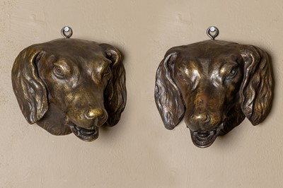 Lot 230 - A pair of patinated bronze dog heads