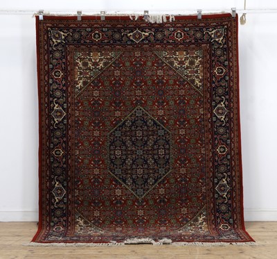 Lot 623 - A modern Kashmiri red ground rug