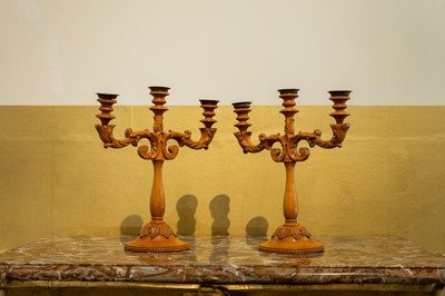 Lot 63 - A pair of Louis XV-style carved fruitwood candelabra