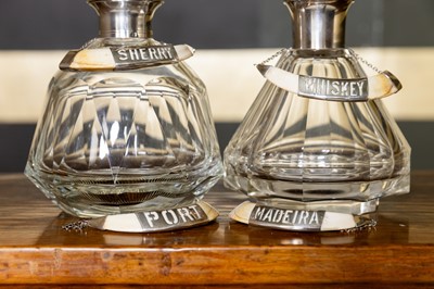 Lot 69 - A set of four silver-mounted boar tusk decanter labels